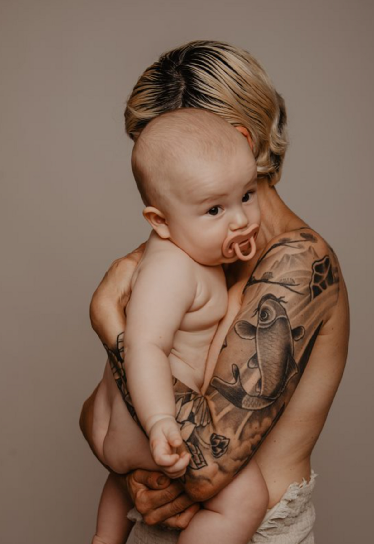 Parent holding a baby using a Suavinex Colour Essence silicone soother