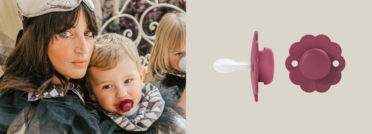 Mother holding her baby who is using a Suavinex Wonder soother, shown alongside the soother